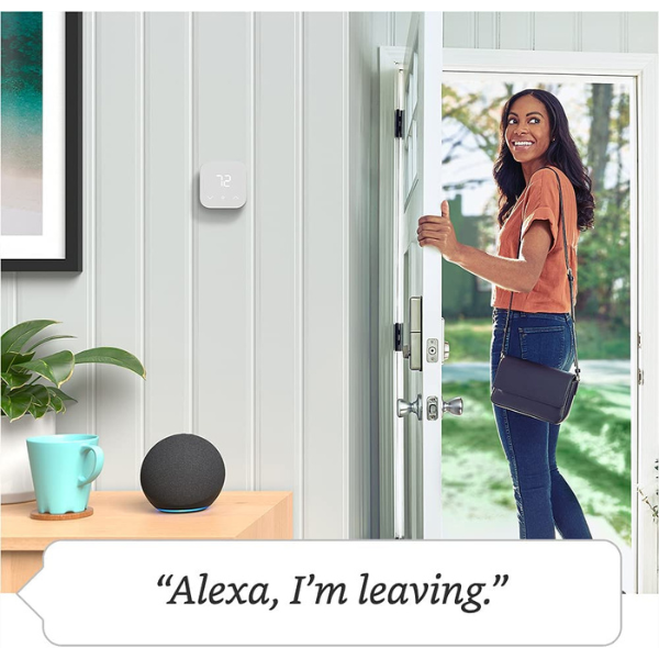 A woman walking out the door of their home with a text box below reading "Alexa, I'm leaving." An Amazon smart thermostat is on the wall. 
