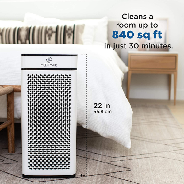 The air purifier on the floor. Measures 22 inches (55.8 cm) tall. Text reads Cleans a room up to 840 square feet in just 30 minutes.