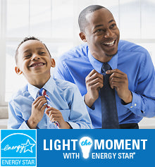 A father and son have big smiles while adjusting their suit ties. The ENERGY STAR logo is shown and text reads “Light the Moment with ENERGY STAR.”