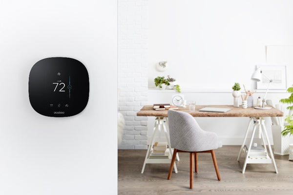 ecobee3 Lite thermostat shown on a wall next to a table and chairs